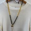 Collar Largo de Madera Negra y Dorada con Colgante Colmillo Blanco