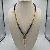 Collar Largo de Madera Negra y Dorada con Colgante Colmillo Blanco